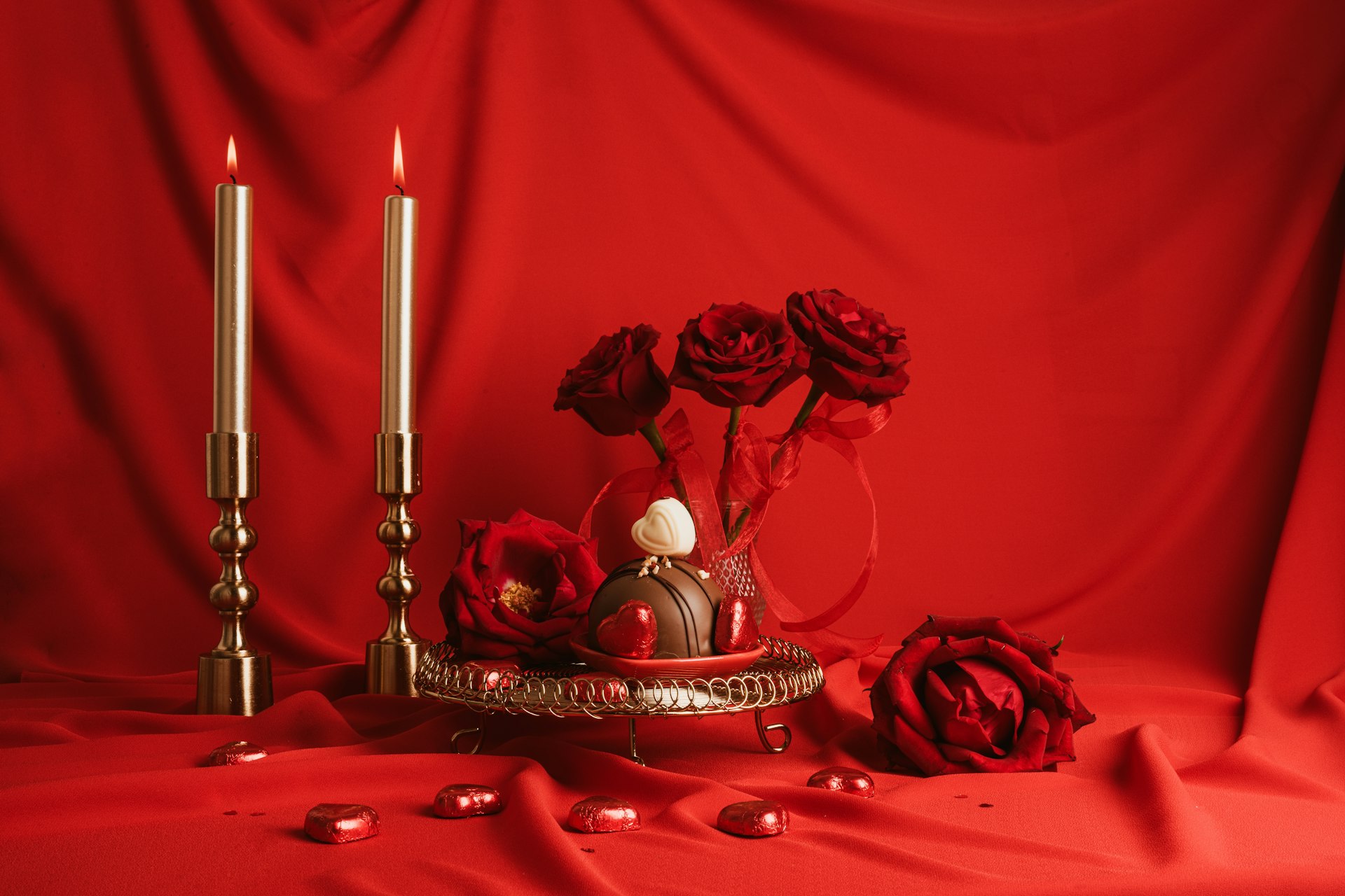 a red background with roses and candles